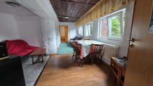a room with a table and chairs and a couch at Apartament de vacanta Criss in Buşteni