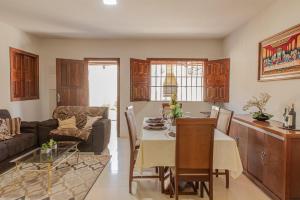 a kitchen and living room with a table and a couch at Recanto do mar in Ilhéus