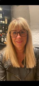 a woman wearing glasses and a leather jacket at Haus Schmölz Ferienwohnung Allgäu in Hopferau