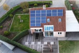 an aerial view of a house with solar panels on it at Owla-Stay in Heusden - Zolder