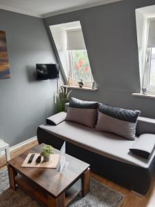 a living room with a couch and a table at Katharinas Ankerplatz in Flensburg