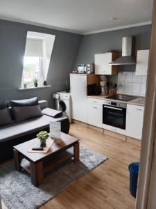 a living room with a couch and a table at Katharinas Ankerplatz in Flensburg