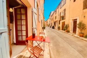 a red table on the side of a street at Cabris Village Escape - Junior Suite in Cabris