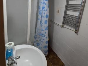 a bathroom with a white toilet and a shower curtain at Apartament de vacanta Criss in Buşteni +13 photos