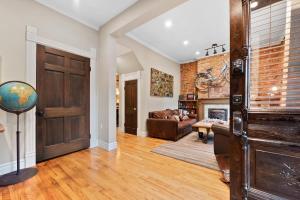 a living room with a wooden door and a fireplace at The Whittier Wonder in Denver