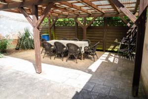 a table and chairs under a wooden pergola at pinocchio pirow in Pirow +3 photos