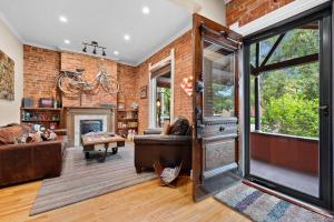 a living room with a brick wall at The Whittier Wonder in Denver