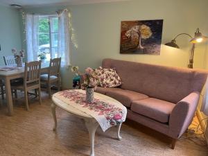 a living room with a couch and a table at Stora Djulö Vandrarhem in Katrineholm +40 photos