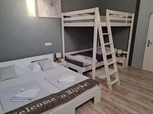 a bedroom with two bunk beds and a ladder at Peron 4-City & Station Stay in Rijeka