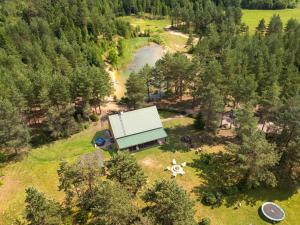 an aerial view of a farm house with a river at Holiday Home Atmatas in Sabile