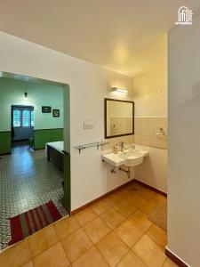 a bathroom with a sink and a mirror at The Thota Mane by evaddo stays in Sakleshpur +40 photos