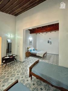 a bedroom with a bed and a desk at The Thota Mane by evaddo stays in Sakleshpur
