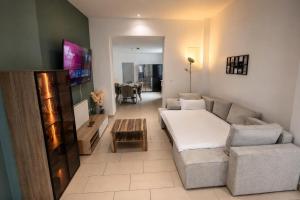 a living room with a couch and a table at Arcade Apartment Bad Oldesloe in Bad Oldesloe
