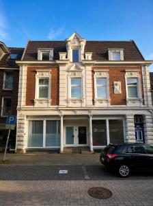 a black car parked in front of a building at Arcade Apartment Bad Oldesloe in Bad Oldesloe