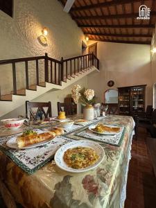a table with two plates of pizza on it at The Thota Mane by evaddo stays in Sakleshpur