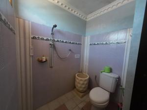 a bathroom with a shower and a toilet and a shower at Fathin Hotel Bawean Syariah in Sangkapura +68 photos