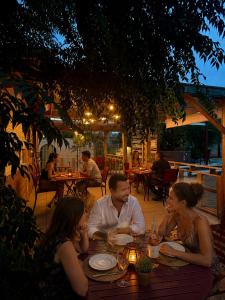 a group of people sitting at a table in a restaurant at Casa di Floumy in Calvi