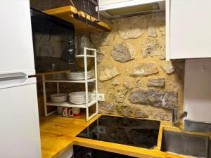 a kitchen with plates on a stone wall at Casita in Castrojeriz +2 photos