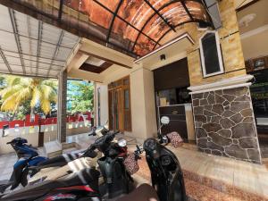a group of scooters parked in a room at Fathin Hotel Bawean Syariah in Sangkapura