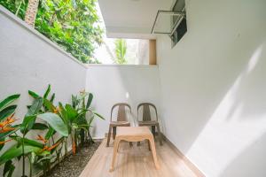 two chairs sitting on a porch with plants at Vega Haven in Matara +5 photos