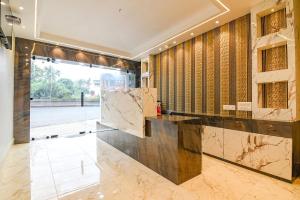 a lobby with a marble counter and a large window at J P Guest House in Howrah +5 photos