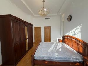 a bedroom with a bed and a clock on the wall at HomeLand in Almaty