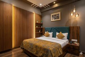 a bedroom with a large bed with a green headboard at Hotel Grand Heaven in Tājganj