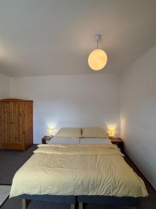 a bedroom with a bed and two lamps on two tables at Hotel Koruna in Roudnice nad Labem