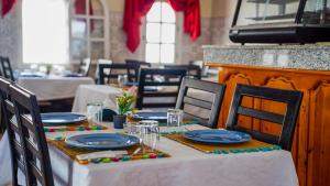 a table with a white tablecloth and blue plates on it at Le Lagon Bleu Oualidia in Oualidia