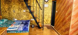 a room with a bed with a magazine on it at Kalathil Guest House in Vagamon