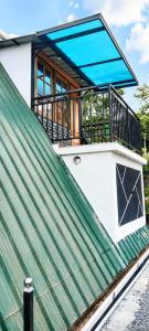 a house on top of a green roof at Kalathil Guest House in Vagamon