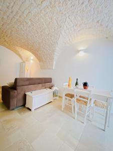 a living room with a couch and a table at Dimora Le Volte Ostuni in Ostuni