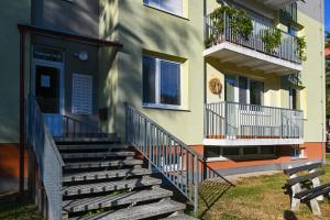 a stairway leading to a building with a sign on it at Sowa Rigpa apartmán in Gerlachov