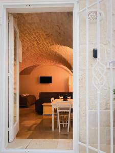 a living room with a table and a couch at Dimora Le Volte Ostuni in Ostuni