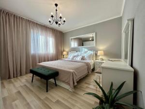 a bedroom with a bed and a chandelier at Villa Silente in Oklaj +65 photos