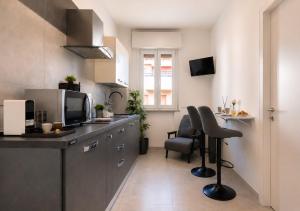 a kitchen with a counter and a table and chairs at Mellini Living in Misano Adriatico