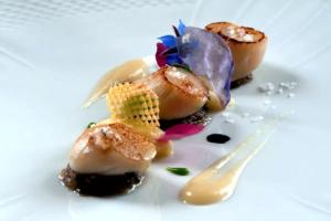 a plate with some food on a white plate at EGO' Marine Sea View, Marina di Mandatoriccio in Mandatoriccio Marina