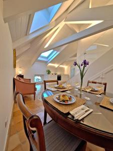 a dining room with a table and a ceiling with skylight at Odisseo Apartments in Minori