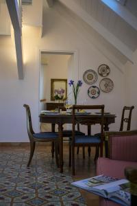 a dining room with a table and chairs and a mirror at Odisseo Apartments in Minori