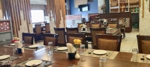 a dining room with tables and chairs in a restaurant at 9 orchid Parbhat royal in Gobindgarh