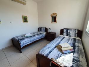 a bedroom with two beds and a mirror at HomeSweetHome in Paphos
