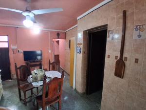 a dining room with a table and a room with a tv at Casa Chicho in Santiago del Estero