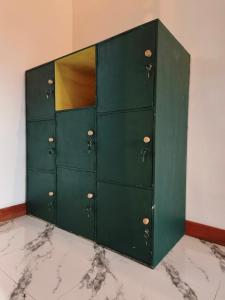 a green locker with ajar doors in a room at Snooze hostel lombok in Selong Belanak
