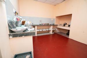 a kitchen with a counter with dishes on it at Rani Alfred in Viramanikkatevanturai