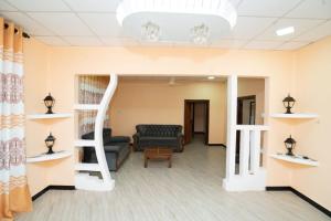 a living room with a loft bed and a couch at Rani Alfred in Viramanikkatevanturai +18 photos