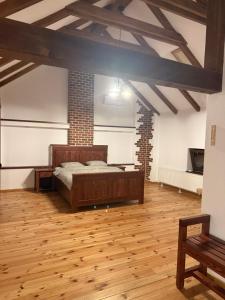 a bedroom with a bed in a room with wooden floors at Ohaba 140-141 By Holztreppe in Ohaba