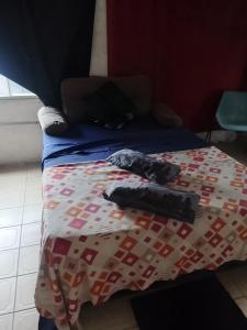 a bed with a comforter on top of it at Fabylu in Ezpeleta