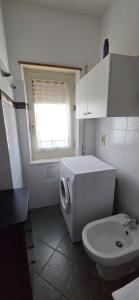 a small bathroom with a toilet and a sink at Civico 22 Guest House in Pellaro +9 photos