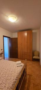 a bedroom with a bed and a cabinet and a chair at Civico 22 Guest House in Pellaro