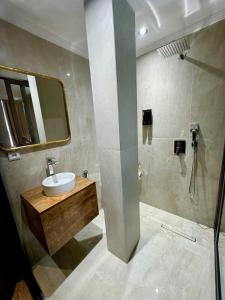 a bathroom with a sink and a shower at Royal Room 5 Chambre Royale in Asilah +23 photos